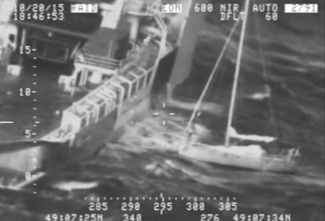 Footage captured the moment a French sailor holding a cat in his sweater risked his life by leaping from his battered yacht to a rescue ship during a fierce storm off Alaska © U.S. Coast Guard